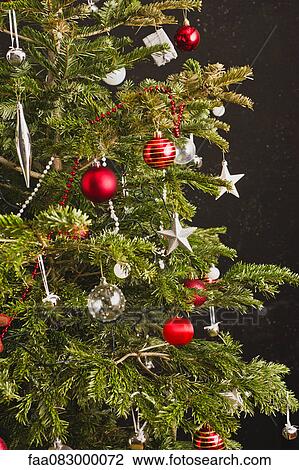 Stock Image - Christmas ornaments on Christmas tree. Fotosearch