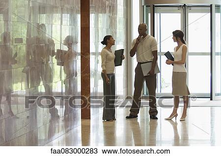 Colleagues talking in lobby, backlit View Large Photo Image Stock Image - Colleagues talking in lobby, backlit. Fotosearch