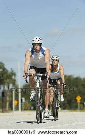 Cyclists cycling on road View Large Photo Image Stock Photo - Cyclists cycling on road. Fotosearch