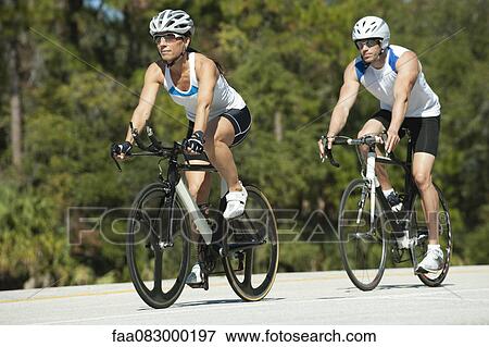 Cyclists cycling on road View Large Photo Image Stock Photo - Cyclists cycling on road. Fotosearch