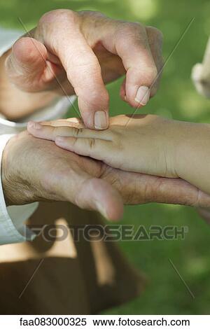 Elderly person holding child's hand, cropped View Large Photo Image Stock Photography - Elderly person holding child's hand, cropped. Fotosearch