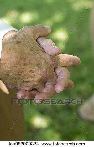 Picture - Elderly person's clasped hands. Fotosearch