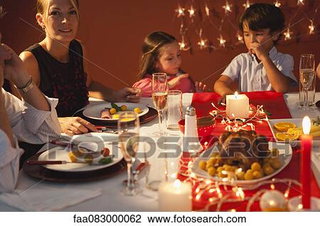 Family gathered around table for Christmas dinner View Large Photo Image Stock Image - Family gathered around table for Christmas dinner. Fotosearch