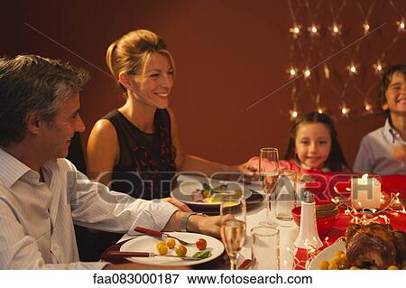 Stock Photo - Family having Christmas dinner. Fotosearch