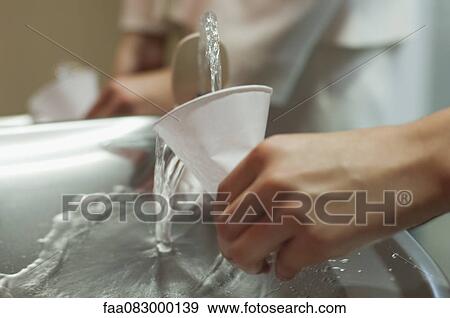 Filling cup at drinking fountain, cropped View Large Photo Image Stock Photo - Filling cup at drinking fountain, cropped. Fotosearch