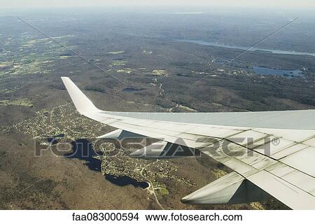 Focus on an airplane wing, flying united states View Large Photo Image Picture - Focus on an airplane wing, flying united states. Fotosearch