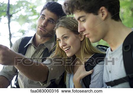 Stock Photograph - Friends hiking in woods. Fotosearch
