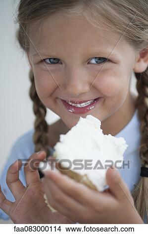 Girl eating piece of cake View Large Photo Image Picture - Girl eating piece of cake. Fotosearch