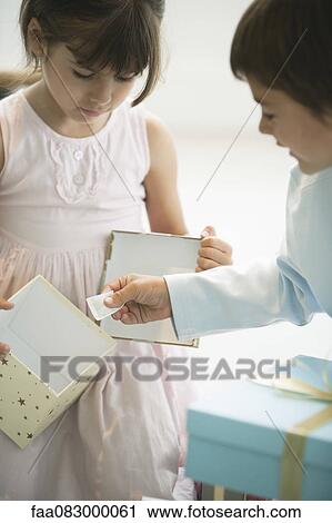 Stock Image - Girl opening gift box. Fotosearch
