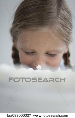 Girl with cake icing on nose View Large Photo Image Stock Photo - Girl with cake icing on nose. Fotosearch