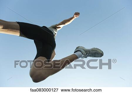 Stock Photo - Man jumping in air, directly below. Fotosearch