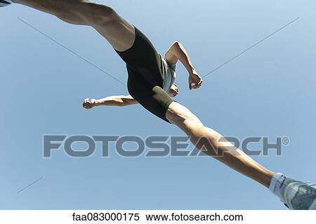 Man jumping in air, directly below View Large Photo Image Stock Photography - Man jumping in air, directly below. Fotosearch