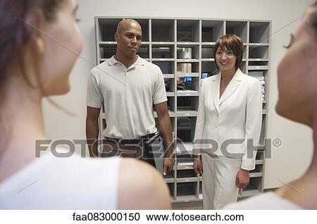 Stock Image - Manager and colleagues in discussion. Fotosearch