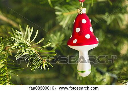 Stock Photo - Mushroom shaped Christmas ornament on tree. Fotosearch