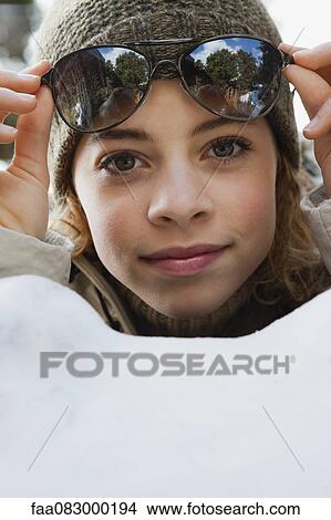 Preteen girl lifting sunglasses View Large Photo Image Picture - Preteen girl lifting sunglasses. Fotosearch