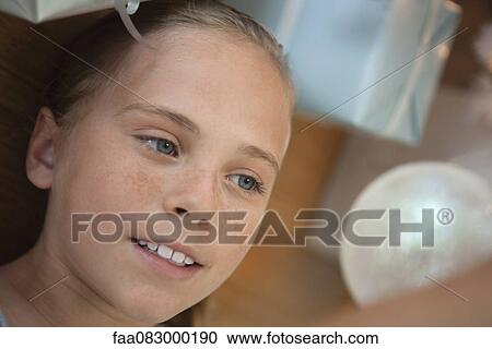Preteen girl lying on floor next to gifts View Large Photo Image Stock Image - Preteen girl lying on floor next to gifts. Fotosearch