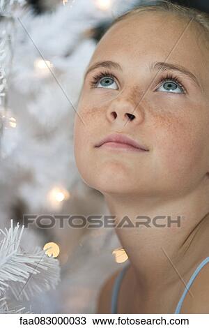 Preteen girl next to Christmas lights View Large Photo Image Stock Image - Preteen girl next to Christmas lights. Fotosearch
