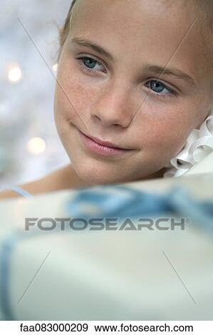 Preteen girl surrounded by presents View Large Photo Image Stock Photo - Preteen girl surrounded by presents. Fotosearch