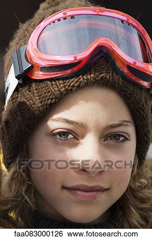 Stock Photograph - Preteen girl with ski goggles, portrait. Fotosearch