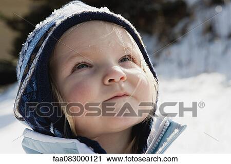 Toddler girl wearing knit hat outdoors, portrait View Large Photo Image Stock Image - Toddler girl wearing knit hat outdoors, portrait. Fotosearch