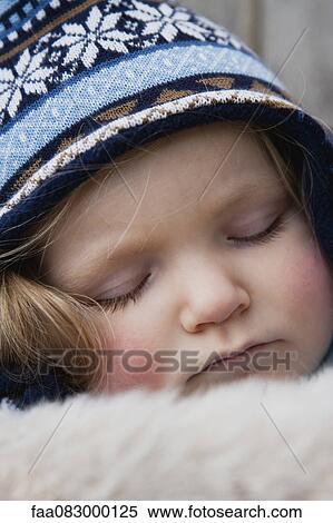 Stock Photography - Toddler girl wearing knit hat sleeping, portrait. Fotosearch