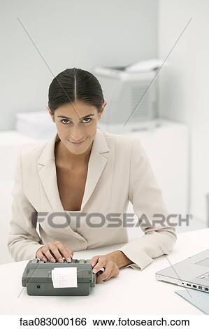 Woman using adding machine in office View Large Photo Image Stock Photograph - Woman using adding machine in office. Fotosearch