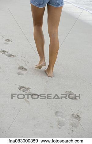 Woman walking on beach, low section View Large Photo Image Stock Photo - Woman walking on beach, low section. Fotosearch