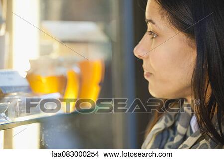 Woman window shopping View Large Photo Image Picture - Woman window shopping. Fotosearch
