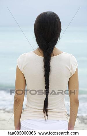 Woman with long braid, rear view View Large Photo Image Stock Photograph - Woman with long braid, rear view. Fotosearch