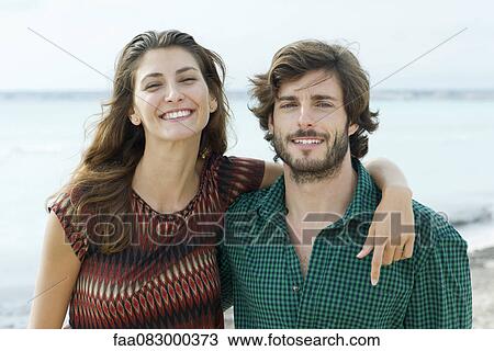 Stock Image - Young couple at the beach, portrait. Fotosearch