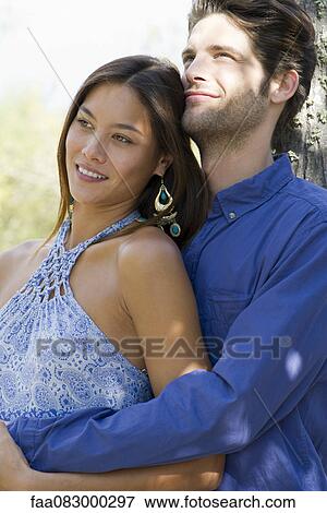 Young couple embracing, portrait View Large Photo Image Stock Photo - Young couple embracing, portrait. Fotosearch