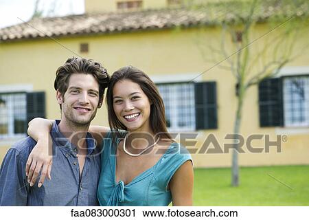 Young couple outdoors, portrait View Large Photo Image Stock Image - Young couple outdoors, portrait. Fotosearch