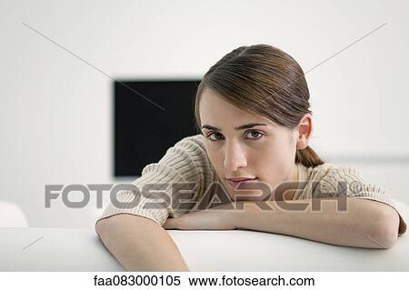 Young leaning over back of sofa, portrait View Large Photo Image Stock Photography - Young leaning over back of sofa, portrait. Fotosearch