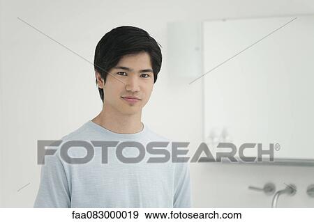 Young man in bathroom, portrait View Large Photo Image Stock Photo - Young man in bathroom, portrait. Fotosearch