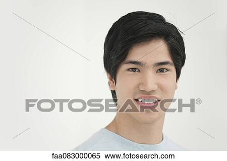 Young man smiling, portrait View Large Photo Image Stock Photography - Young man smiling, portrait. Fotosearch