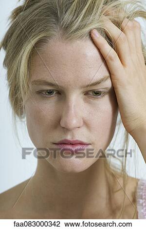Stock Image - Young woman just waking up, portrait. Fotosearch