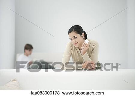Young woman listening to MP3 player View Large Photo Image Stock Photo - Young woman listening to MP3 player. Fotosearch