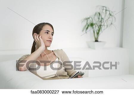 Young woman listening to MP3 player View Large Photo Image Stock Photo - Young woman listening to MP3 player. Fotosearch
