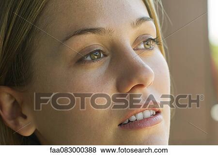 Young woman looking away in thought, portrait View Large Photo Image Stock Photo - Young woman looking away in thought, portrait. Fotosearch