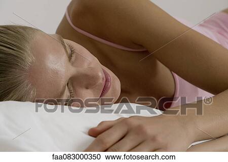 Stock Image - Young woman sleeping. Fotosearch