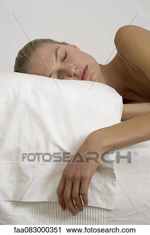 Stock Image - Young woman sleeping. Fotosearch