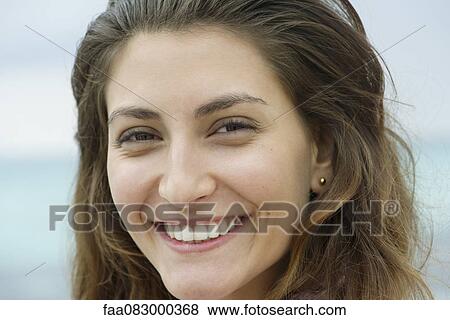 Young woman smiling, portrait View Large Photo Image Stock Photo - Young woman smiling, portrait. Fotosearch