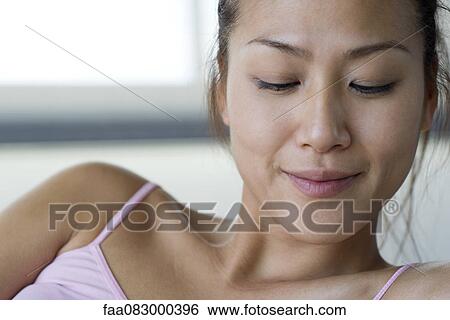 Young woman with eyes half-closed, portrait View Large Photo Image Stock Photograph - Young woman with eyes half-closed, portrait. Fotosearch