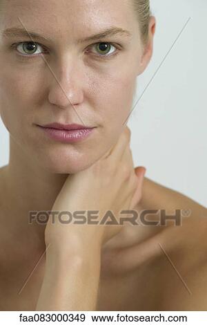 Young woman with hand on neck, portrait View Large Photo Image Stock Photo - Young woman with hand on neck, portrait. Fotosearch