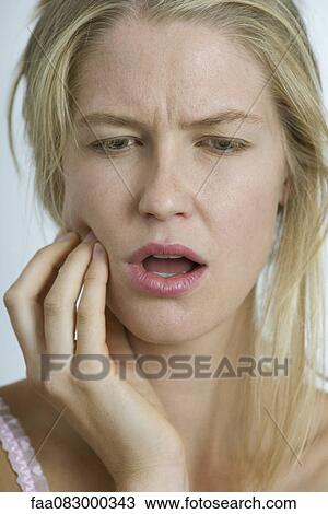 Stock Image - Young woman with toothache. Fotosearch