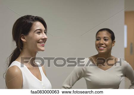 Young women talking and smiling View Large Photo Image Stock Image - Young women talking and smiling. Fotosearch