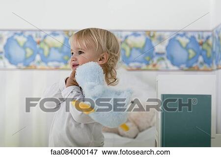 Baby boy carrying stuffed toy on shoulder View Large Photo Image Stock Photo - Baby boy carrying stuffed toy on shoulder. Fotosearch