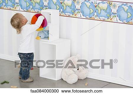 Baby boy getting toy from cubby View Large Photo Image Stock Image - Baby boy getting toy from cubby. Fotosearch