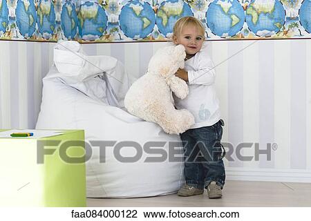 Baby boy holding teddy bear View Large Photo Image Stock Image - Baby boy holding teddy bear. Fotosearch