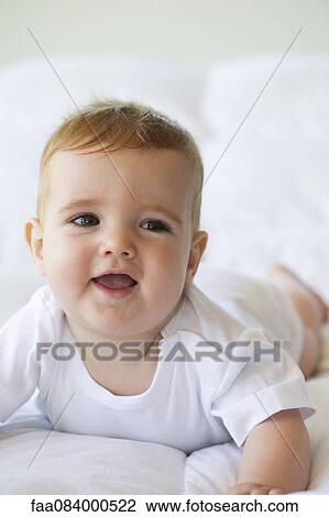 Baby boy lying on stomach, portrait View Large Photo Image Stock Image - Baby boy lying on stomach, portrait. Fotosearch